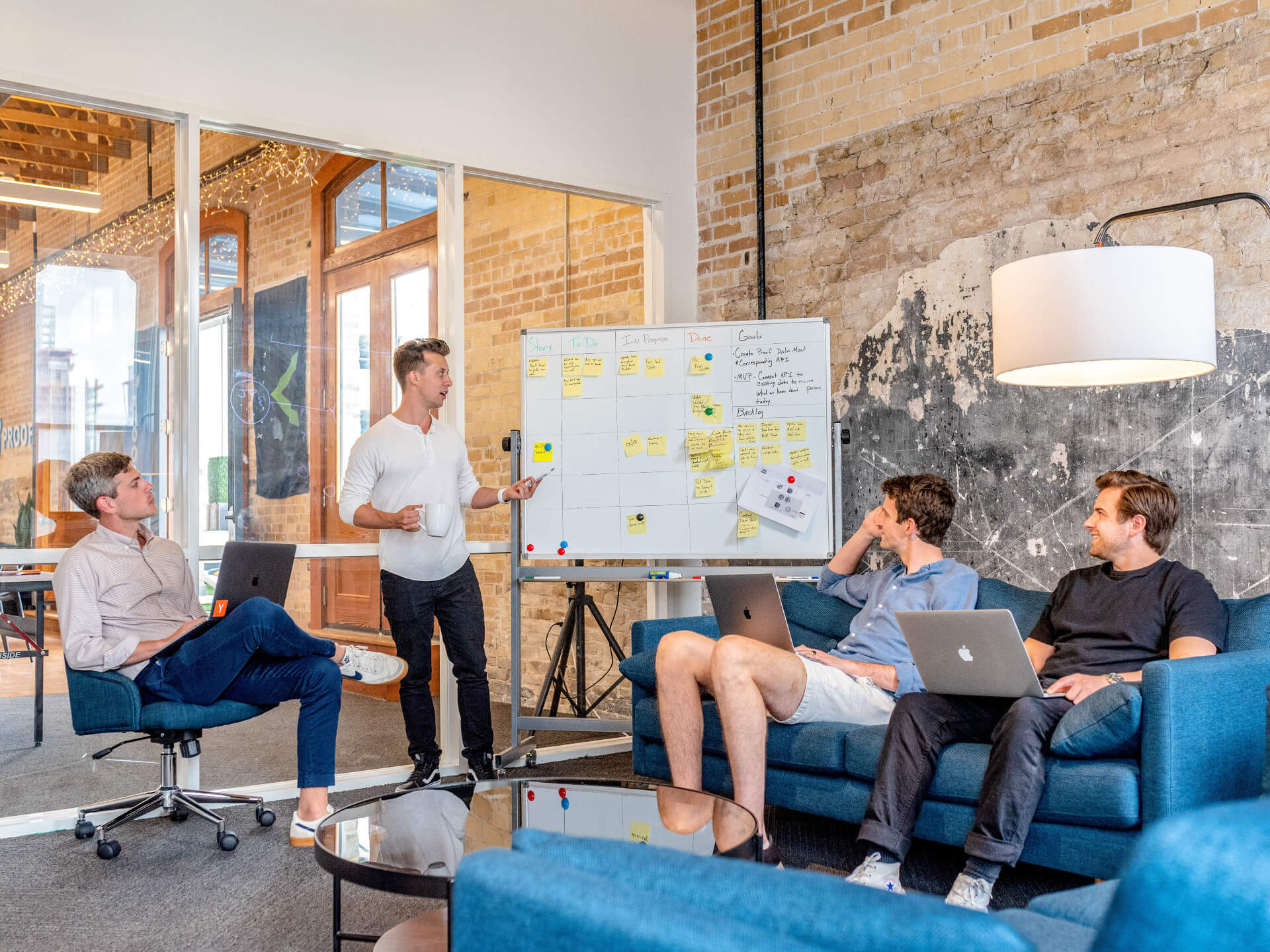 people working together in a room and whiteboarding ideas