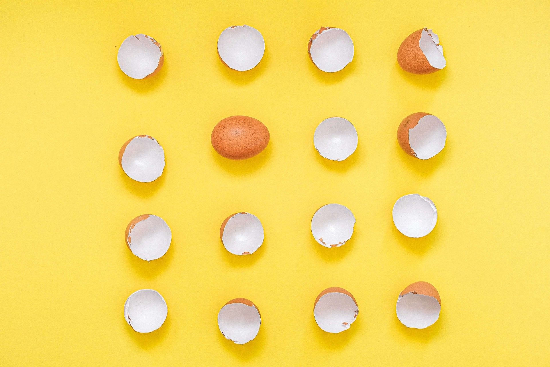 unique value proposition concept with eggs and eggshells on yellow background