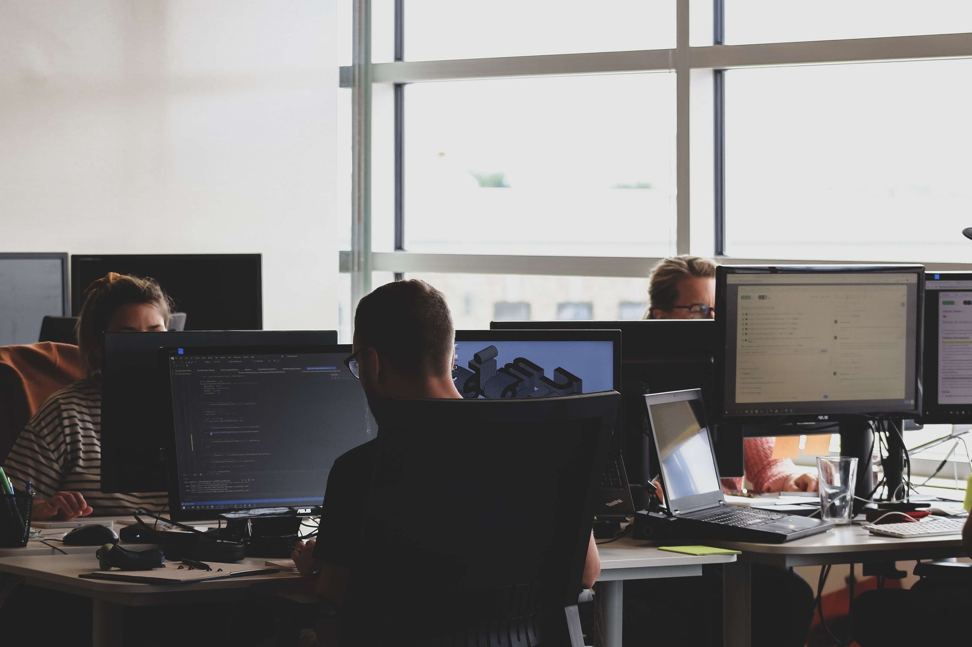 developers writing code in a room