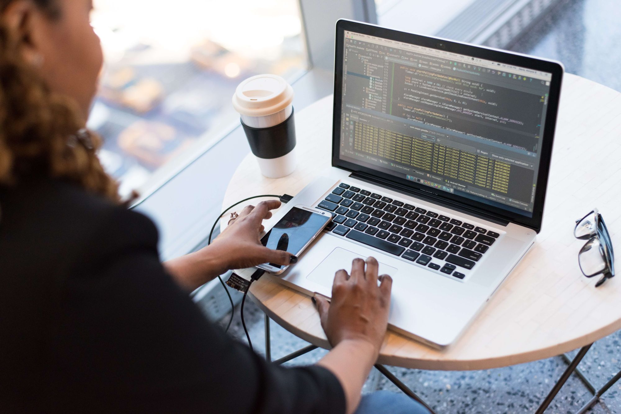 developer working on her laptop, code on screen