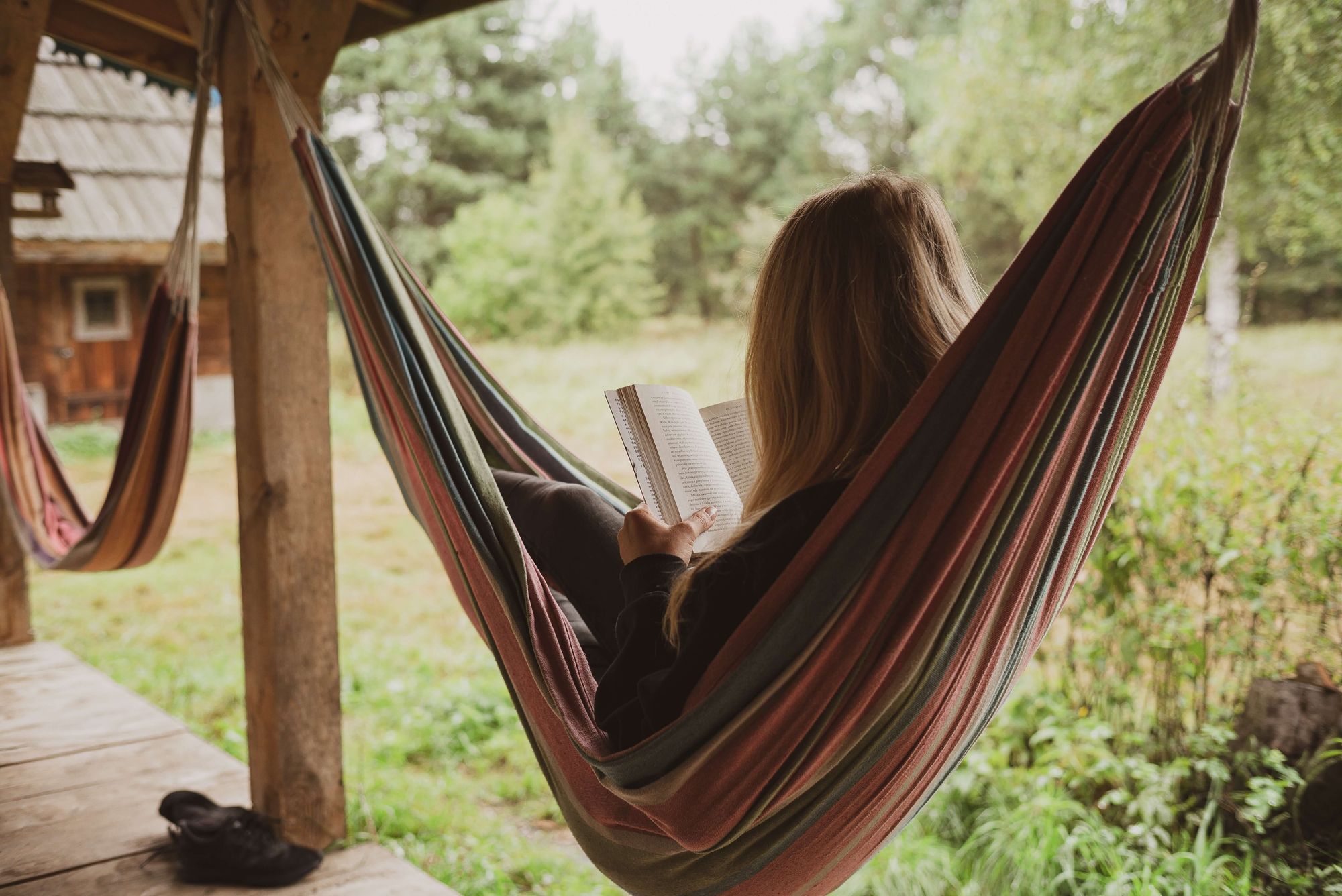 woman reading on a hammock and relaxing